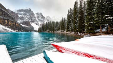 Snow covered canoes in Banff National Park in Canada in March.